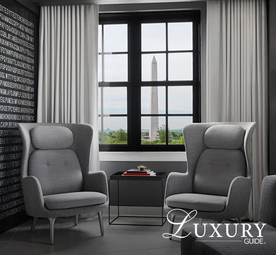 a room with grey chairs and a table