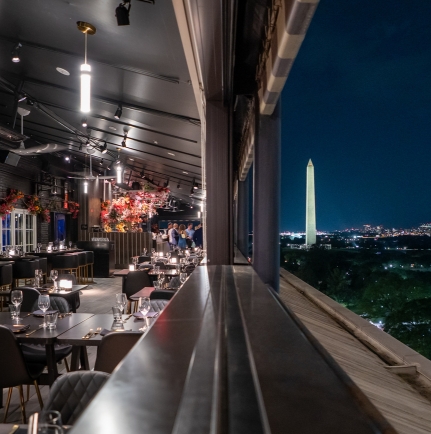a restaurant with a tall tower in the background