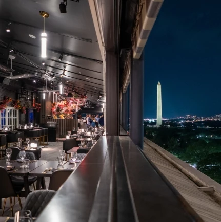 a restaurant with a tall tower in the background