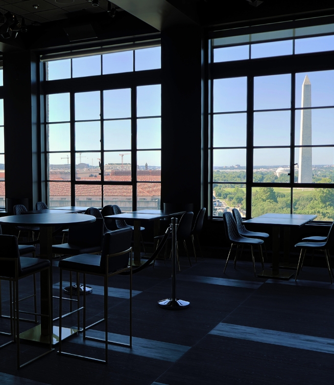a room with tables and chairs and a tall tower