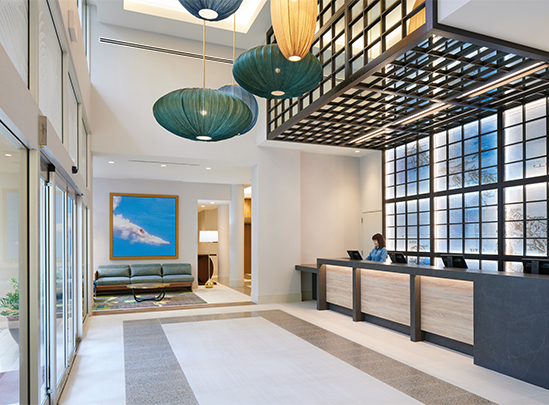 a lobby with a woman at the counter