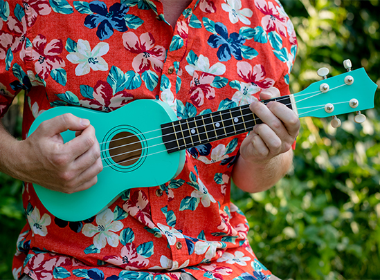 a person playing a small blue ukulele