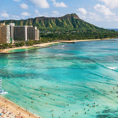 a beach with people swimming in the water