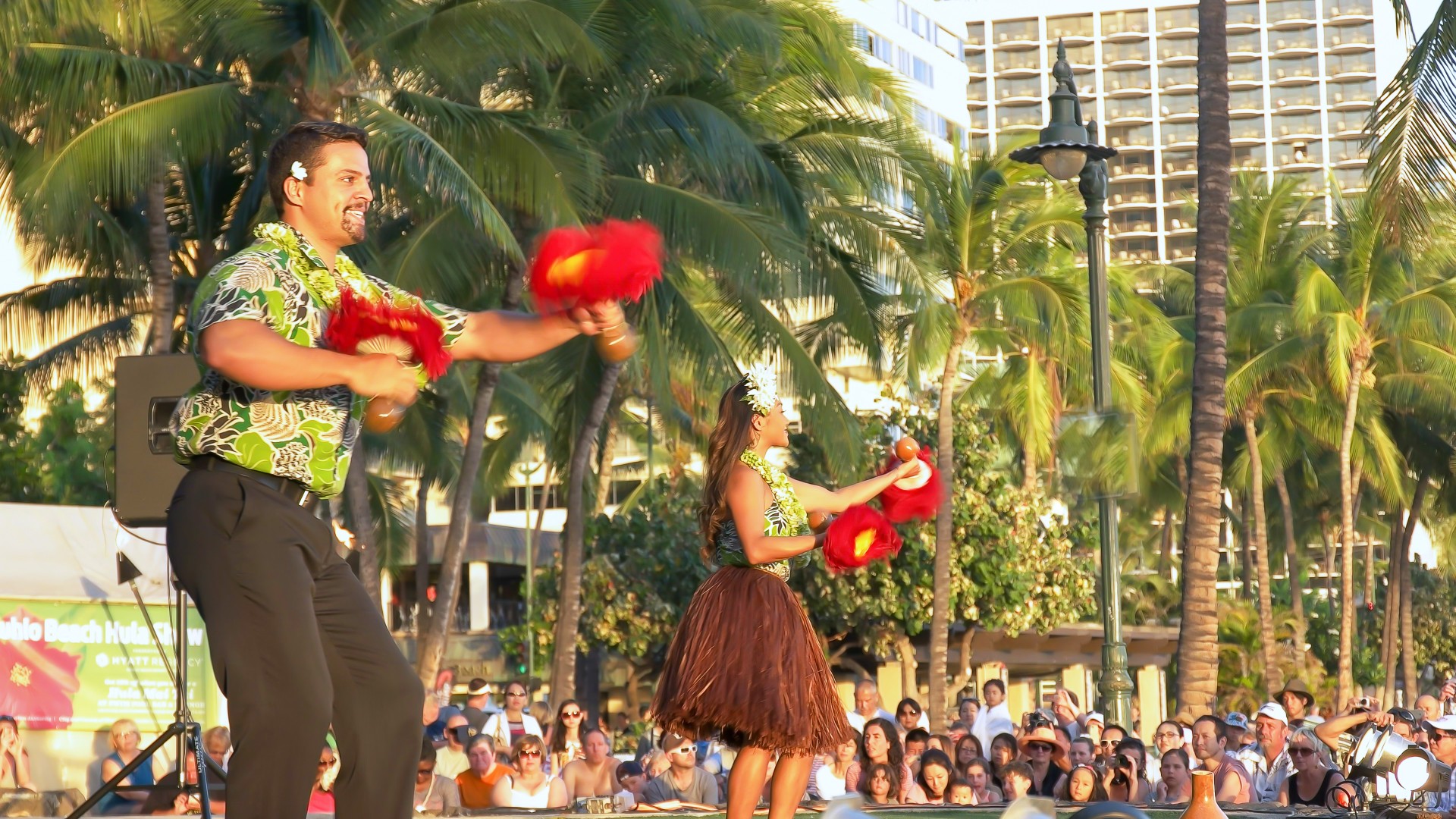 a man and woman performing hula dancing
