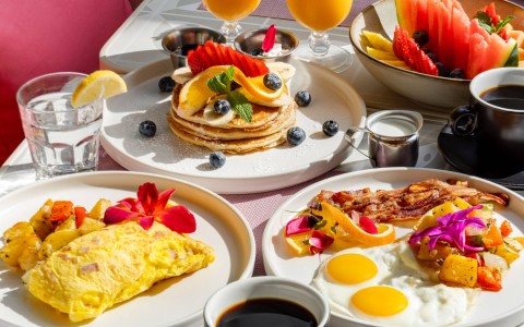 a table with plates of food and drinks
