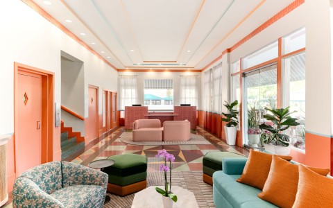 a lobby with a couch and chairs