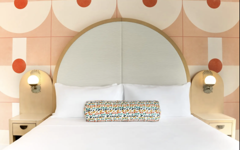 a bed with a round pillow