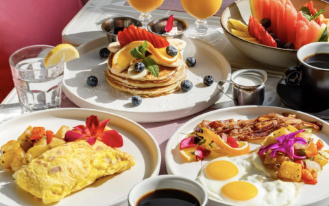 a table with plates of food and drinks