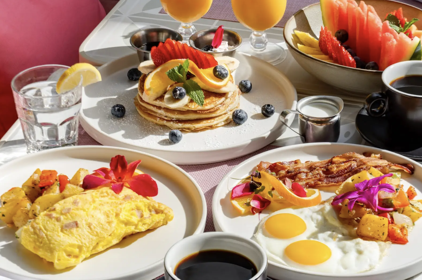 a table with plates of food and drinks