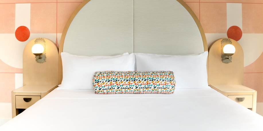 a bed with a round pillow