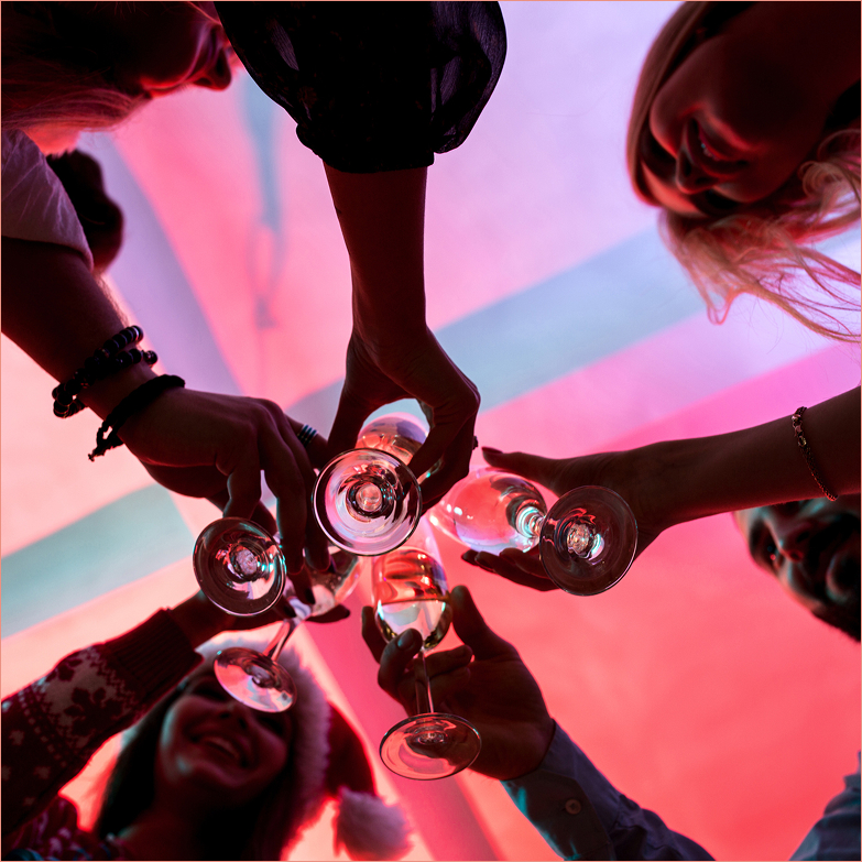 a group of people clinking wine glasses