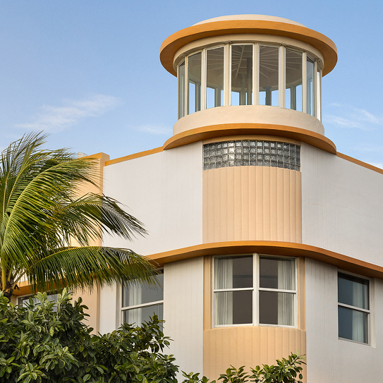 a building with a balcony and palm trees