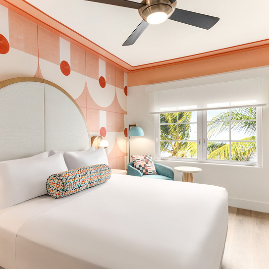 a room with a bed and a fan