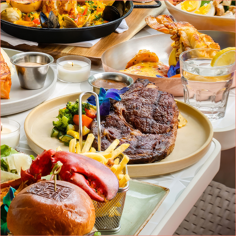 a table with plates of food and a glass of water