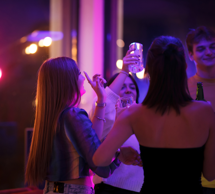 a group of people dancing and drinking