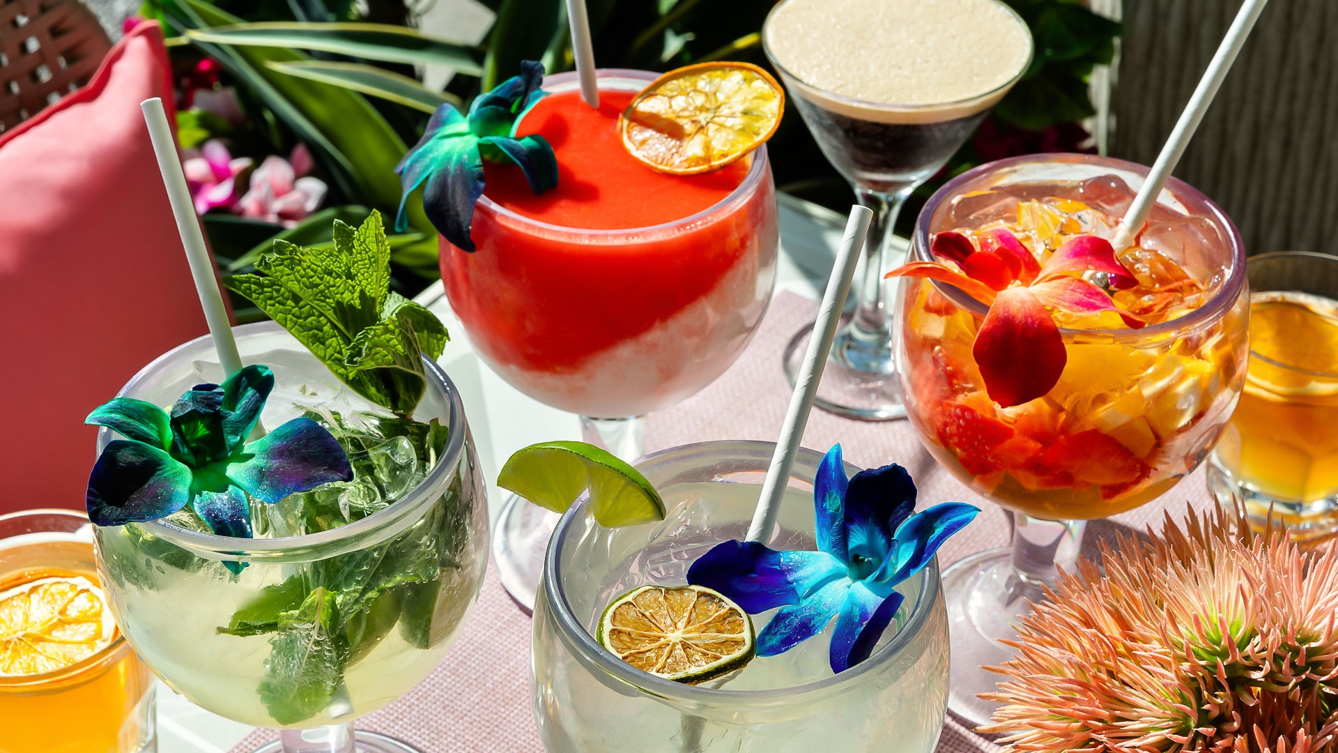 a group of glasses with drinks
