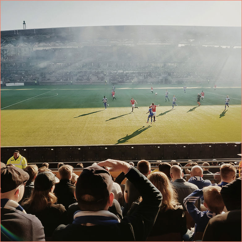 a group of people playing football on a field