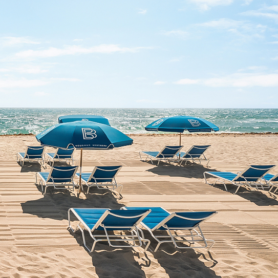 a beach with chairs and umbrellas