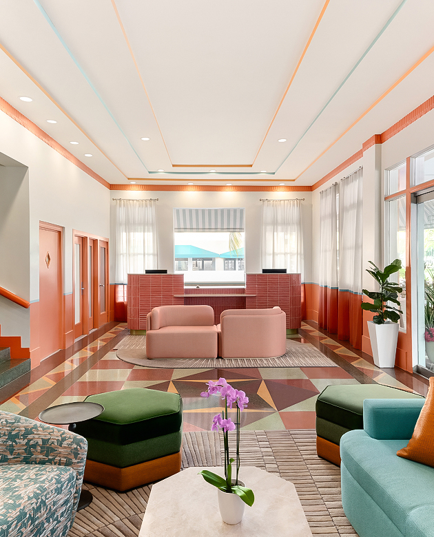 a lobby with colorful furniture and a flower pot