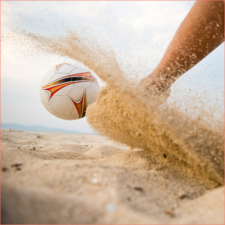 a football ball kicking sand
