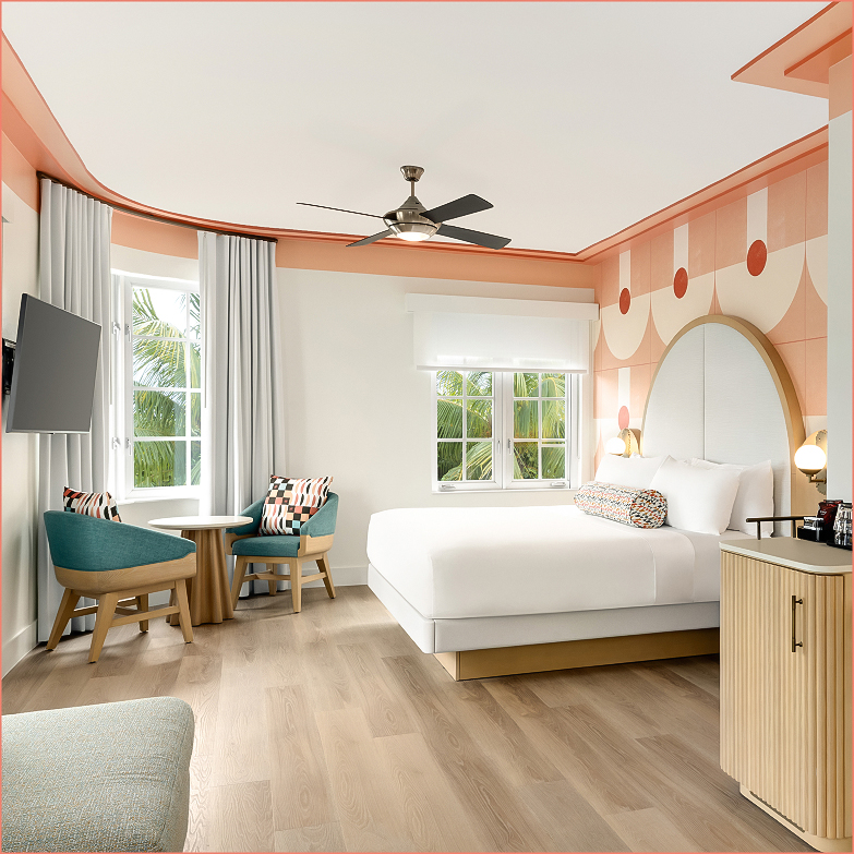 a room with a bed and a table and chairs