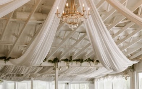 a room with tables and chairs and chandelier