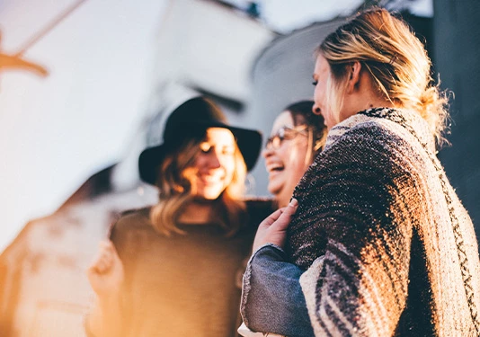 group of three women laughing