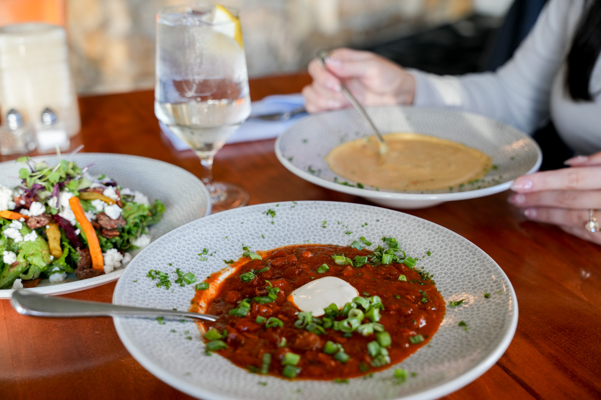 a plate of soup and a glass of water
