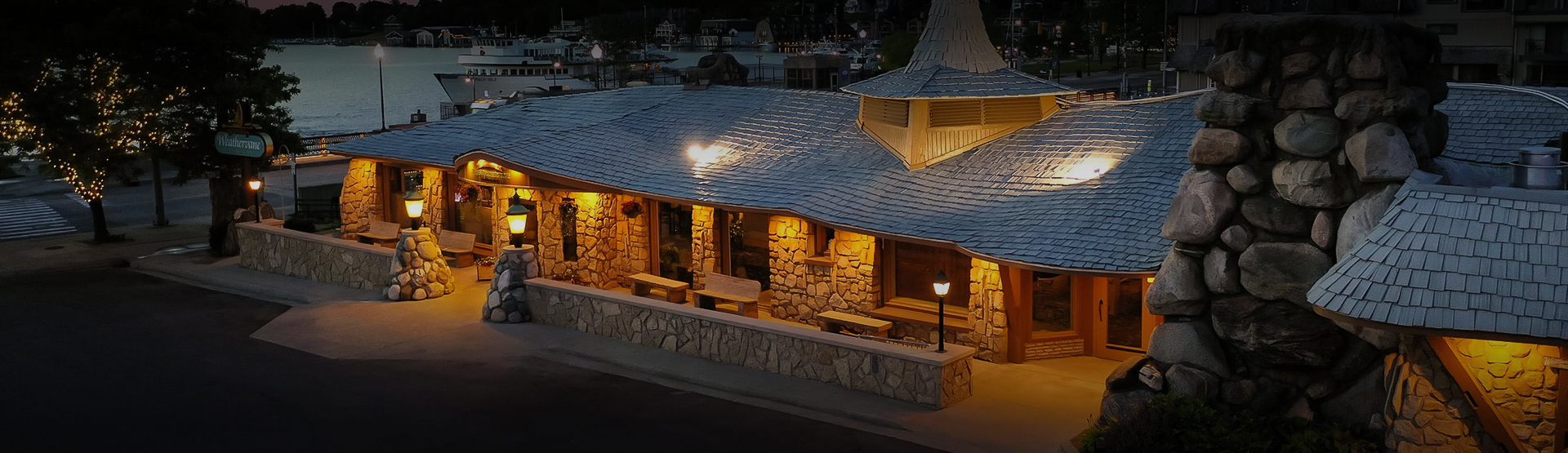 a building with a roof and a stone wall