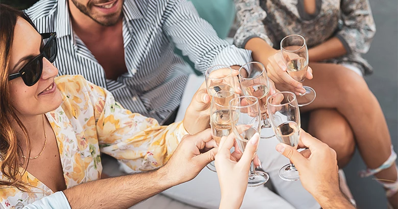 a group of people clinking glasses