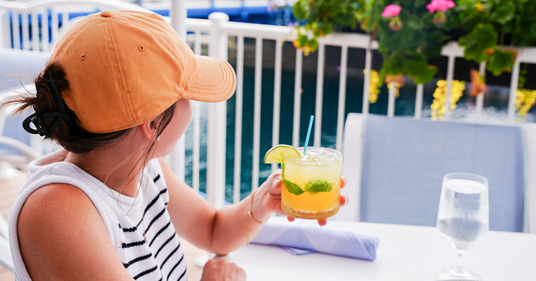 a woman holding a drink