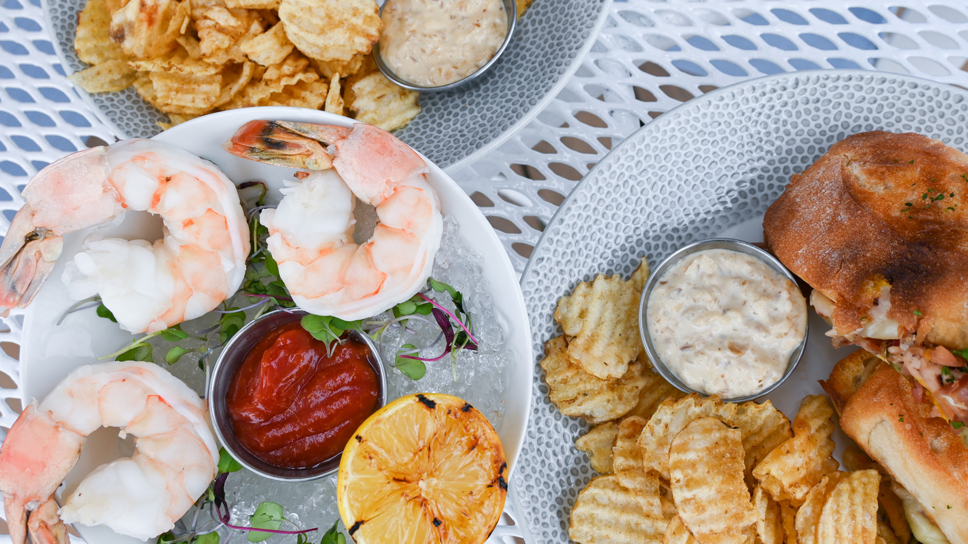 a plate of shrimp and lemons on ice