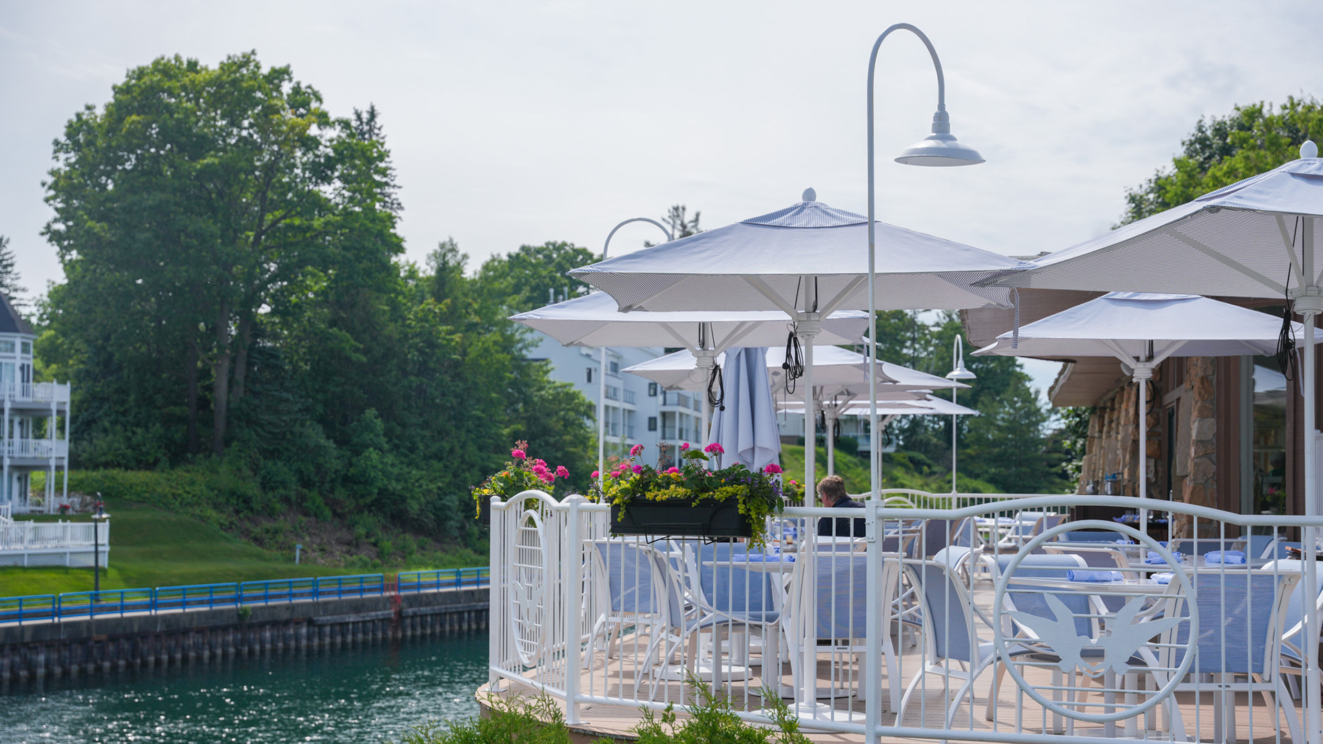a white umbrellas and chairs on a patio