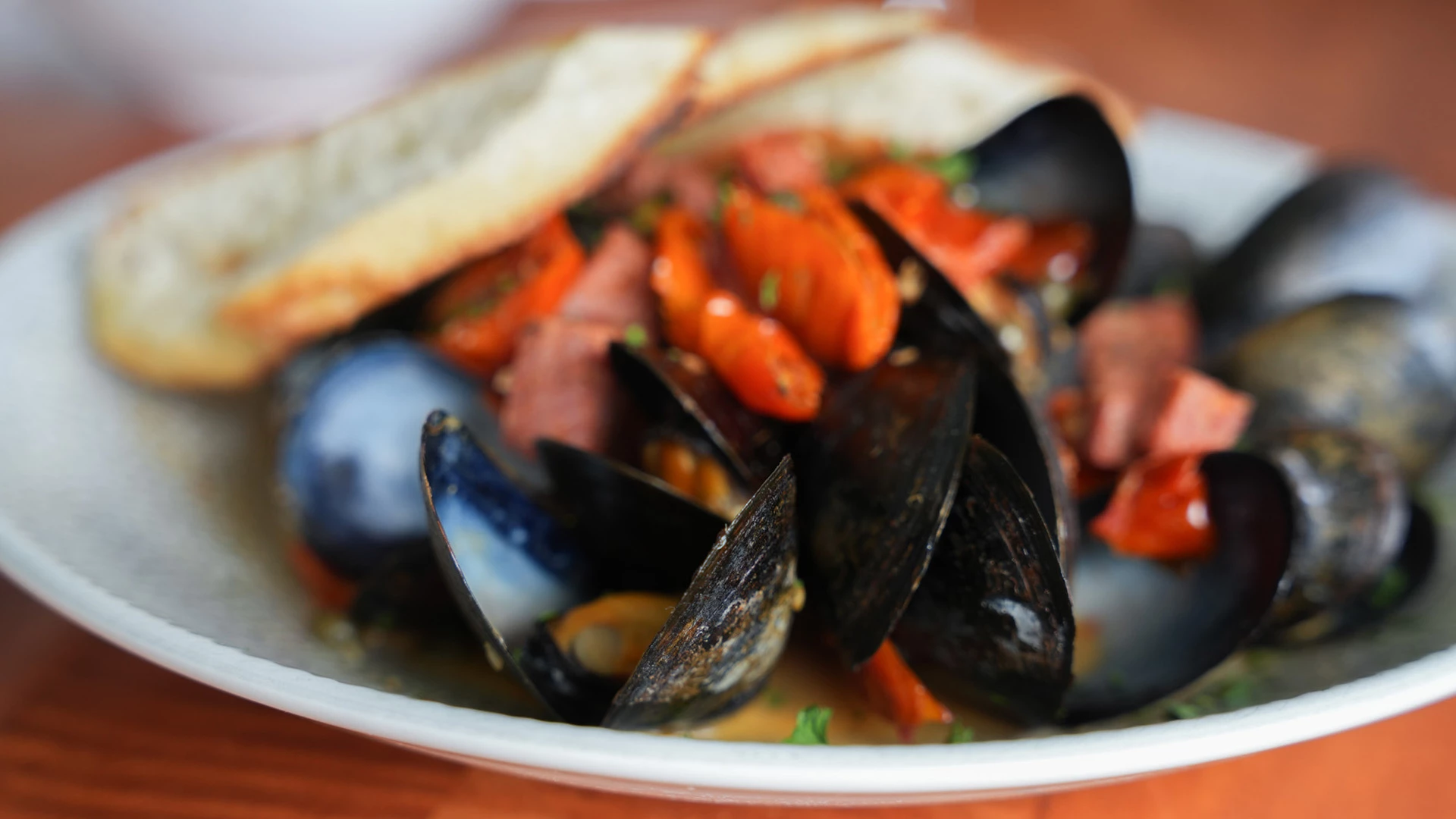 a plate of mussels and bread