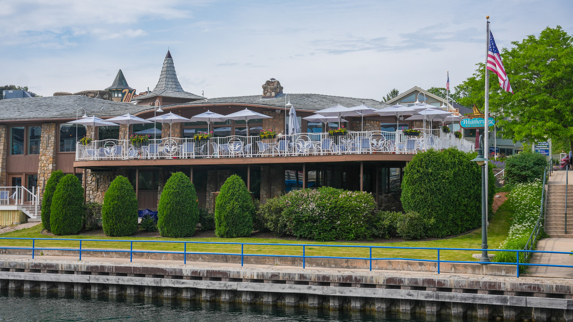 a building with a balcony and umbrellas