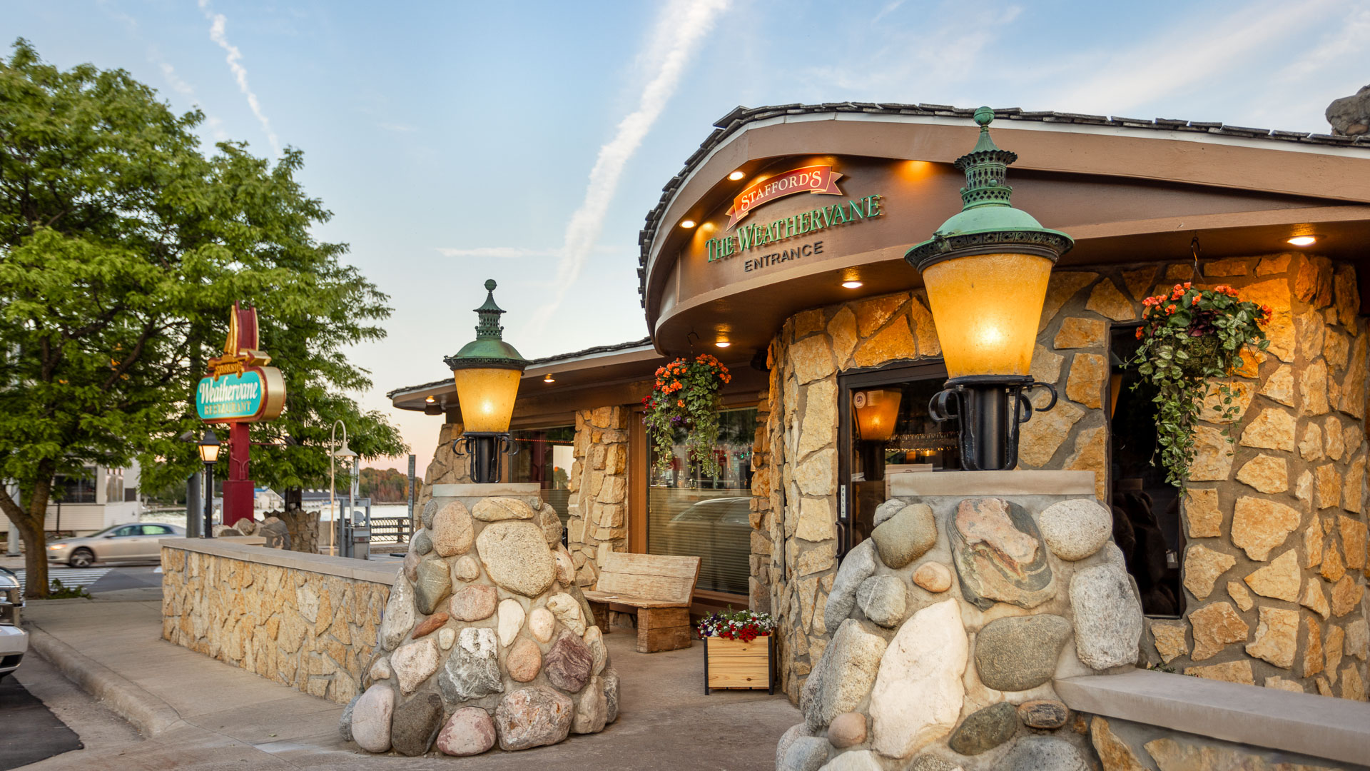 a building with a stone wall and a sign