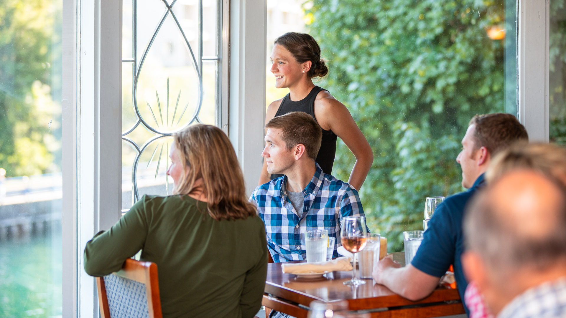 a woman standing in front of a window