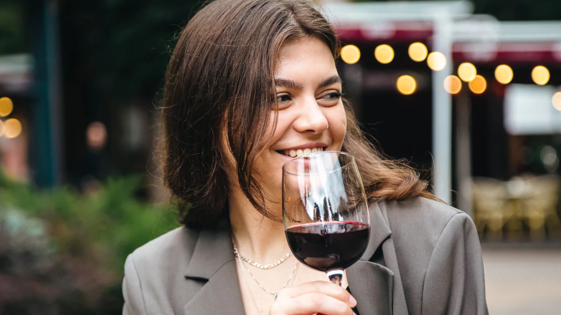 a woman holding a glass of wine