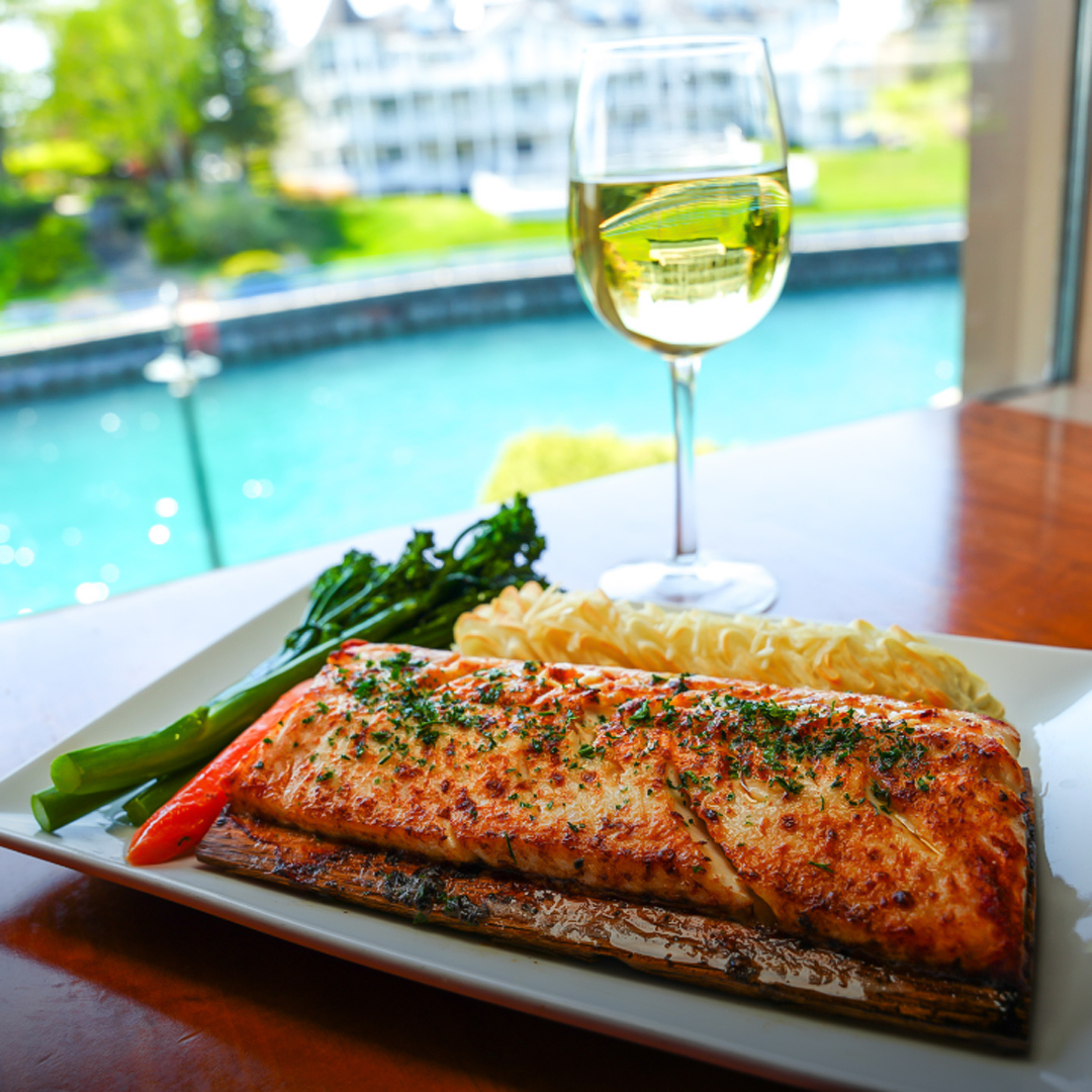 a plate of food and a glass of wine