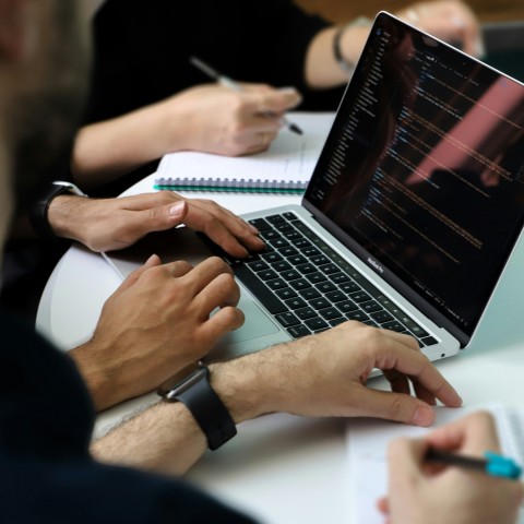 a group of people working on a laptop