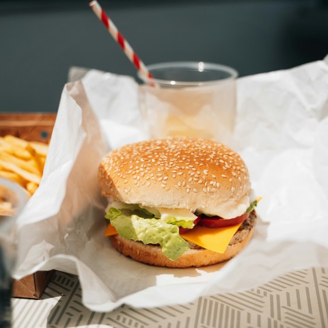 a burger and fries on a paper wrapper