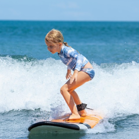 a girl on a surfboard in the ocean