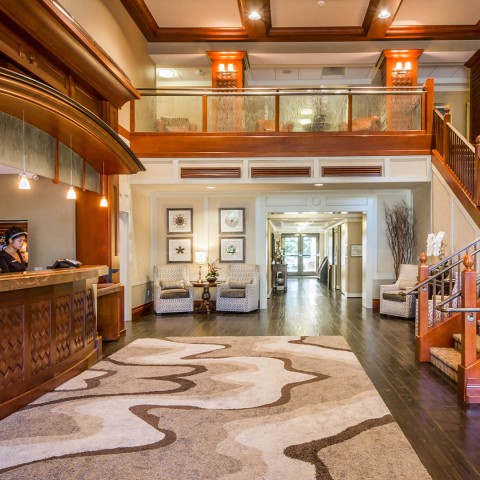 a lobby with a reception desk and a carpet