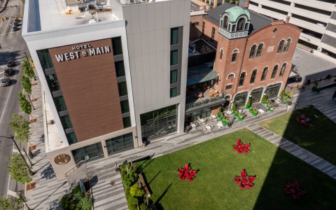 a building with red flowers in the grass