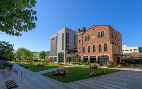 a building with a lawn and chairs in front of it