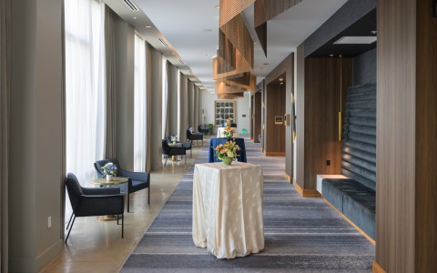 a long hallway with tables and chairs