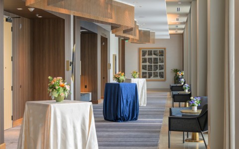 a long hallway with tables and chairs