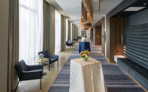 a long hallway with tables and chairs