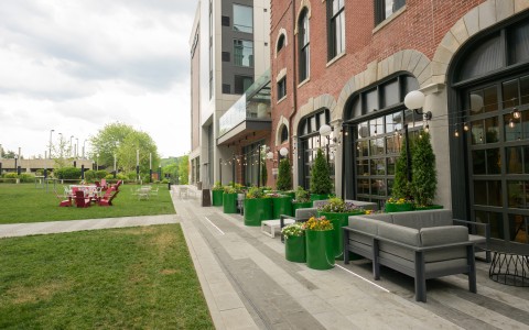 a building with green plants and chairs