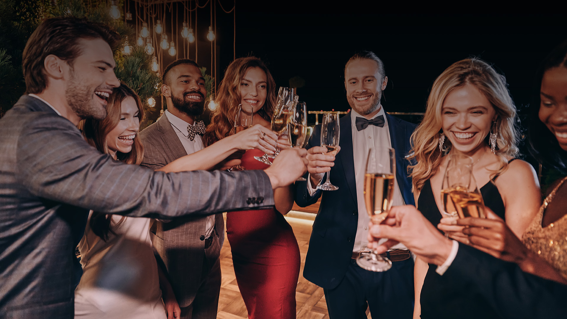 a group of people holding champagne glasses